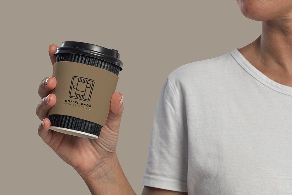 Coffee Mug in Hand branding the logo